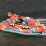 kids on cheat lake on a towed tube